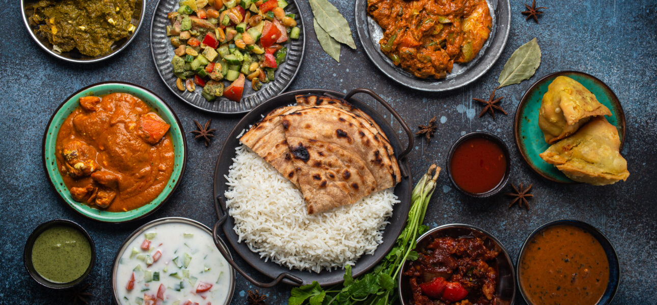 Assorted Indian ethnic food buffet on rustic concrete table