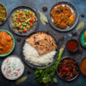 Assorted Indian ethnic food buffet on rustic concrete table