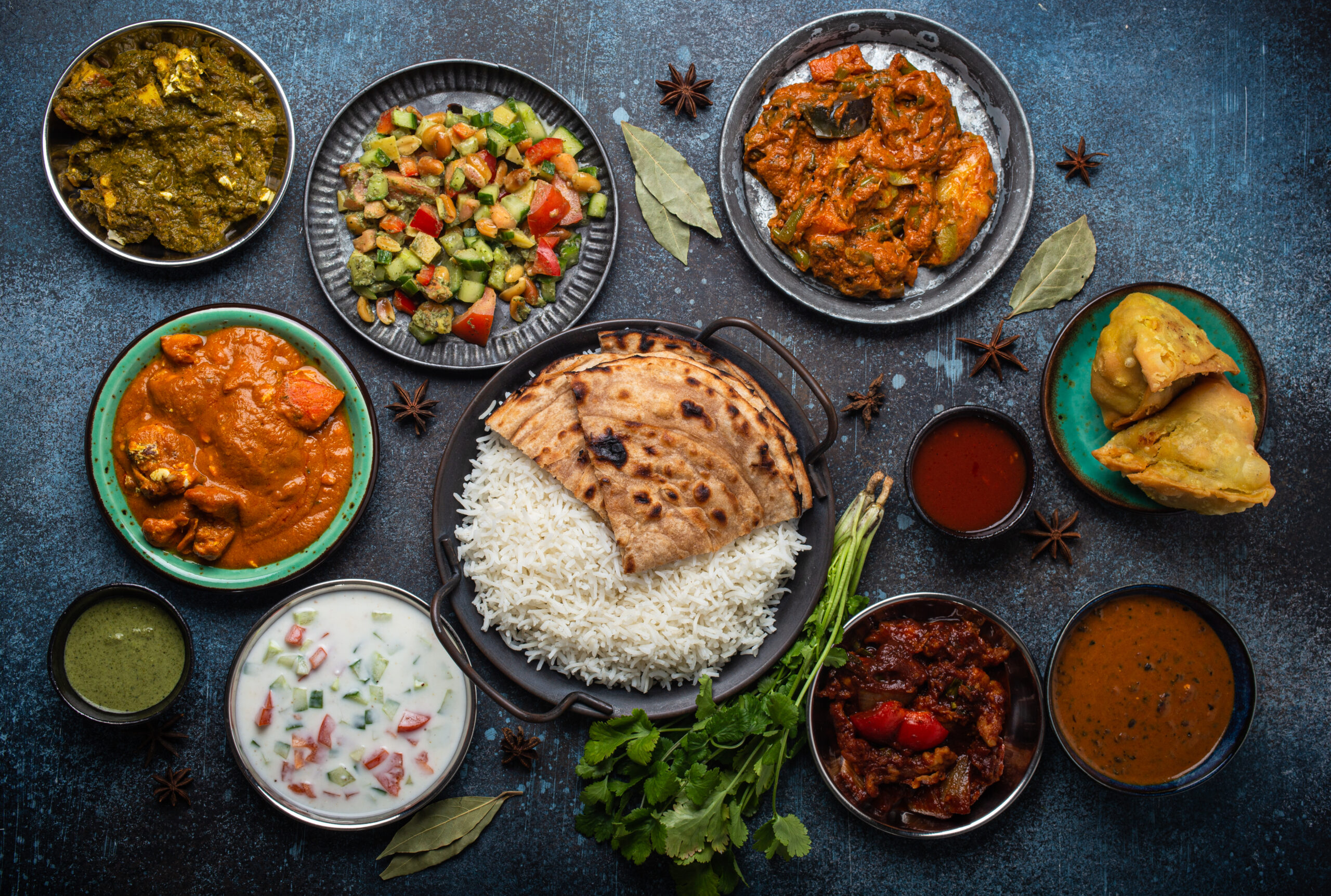 Assorted Indian ethnic food buffet on rustic concrete table